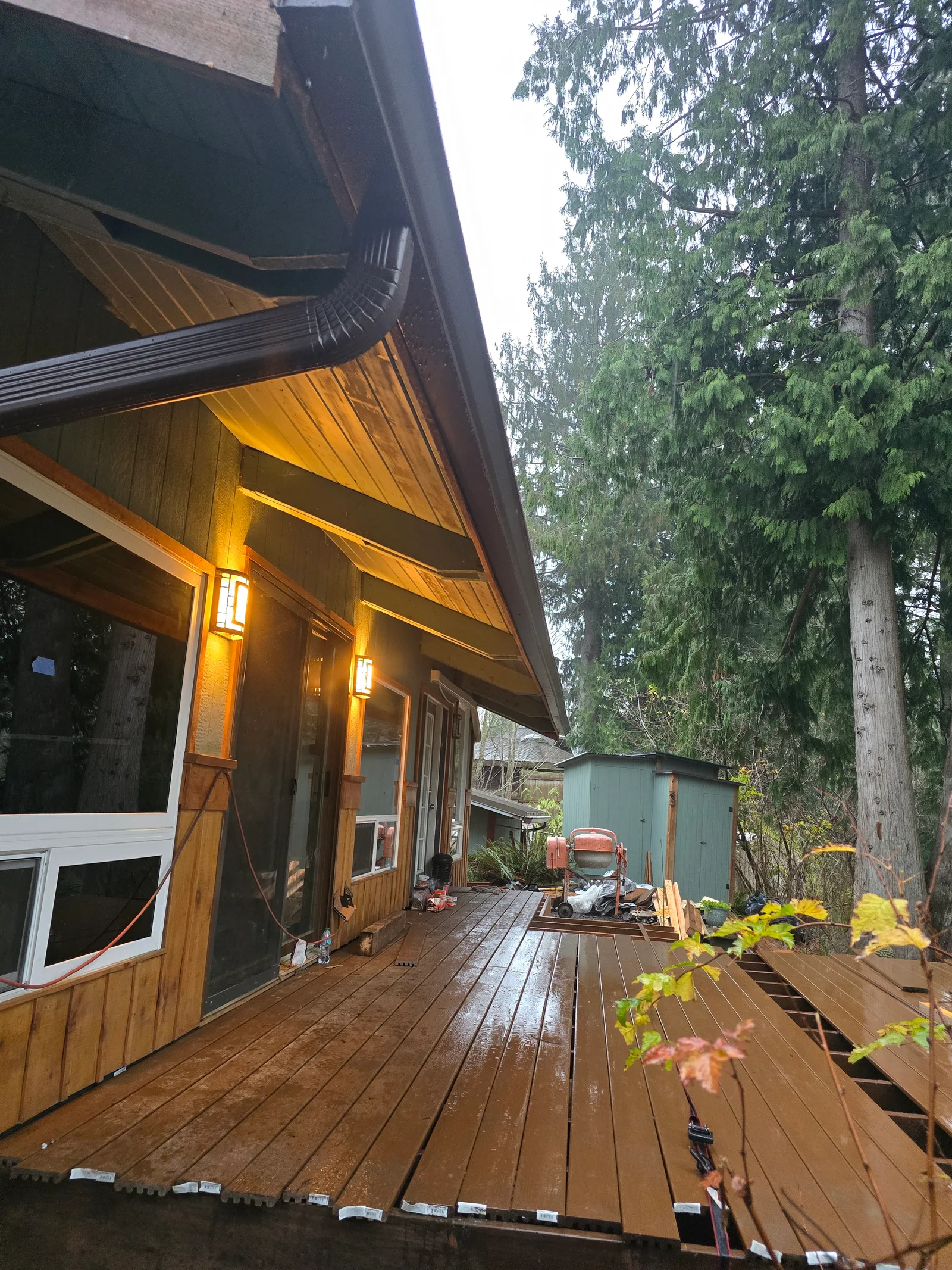Metal gutter and soffit system on modern home with deck and evergreen trees